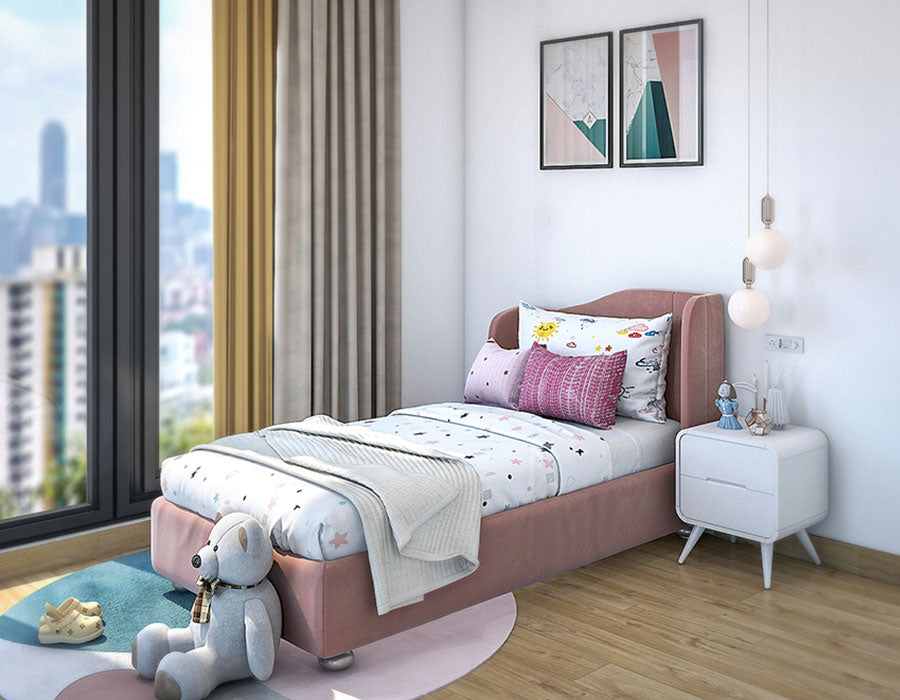 Modern child's bedroom featuring a pink bed, colorful car-themed bedding, and an array of cozy pillows. The room is bright with a large window offering a city view, complemented by light curtains and hardwood flooring. A white bedside table with books and a blue alarm clock sits under contemporary pendant lights, adding charm to this playful and inviting space.