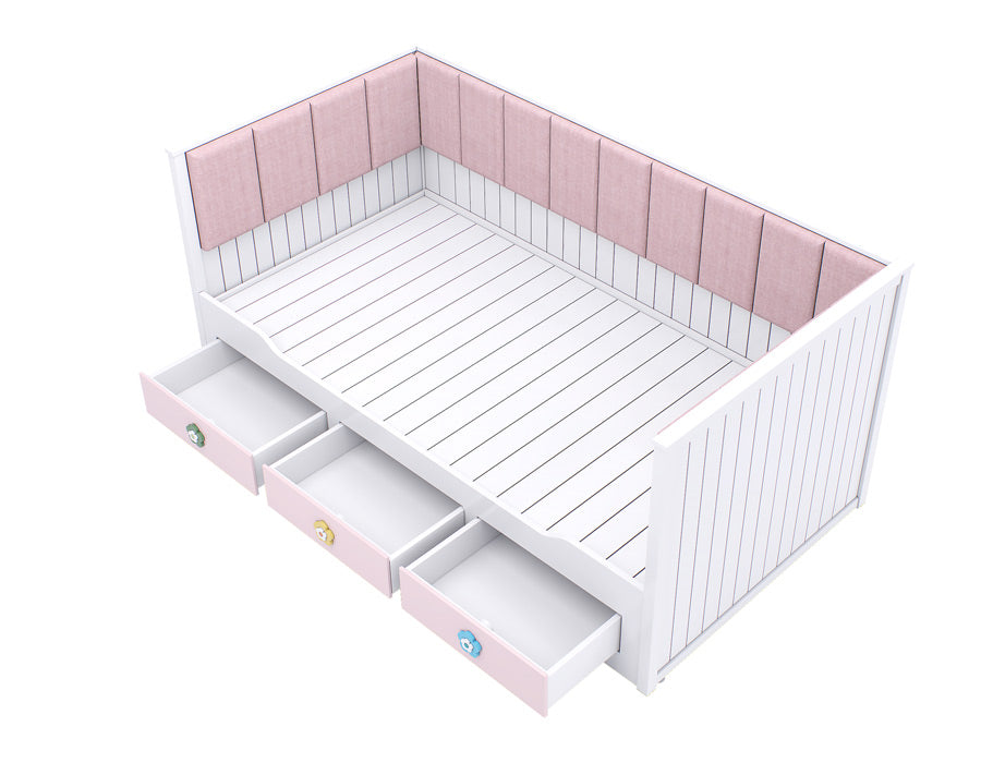 Top view of a stylish girl's trundle bed in white with pink drawers adorned with floral motifs and a plush pink upholstered headboard.