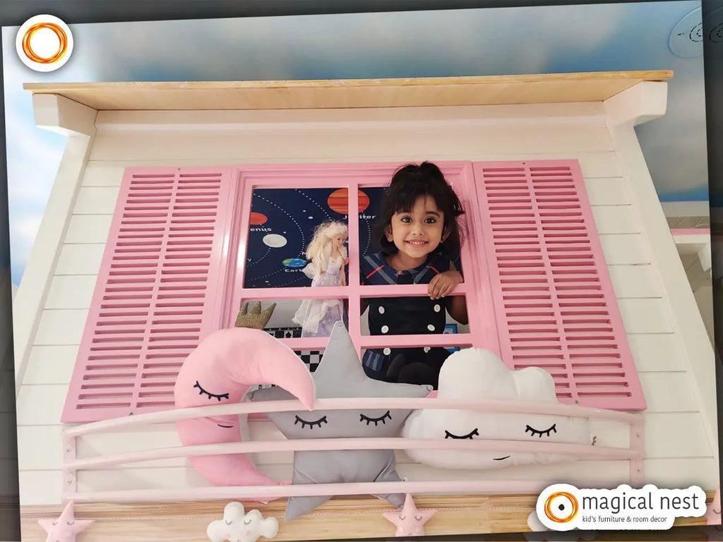 A young girl looking through a pink window from a wooden loft inside her kid's room. 