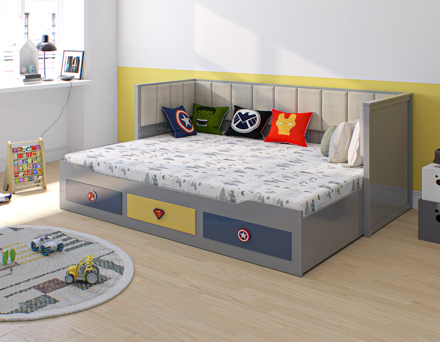 A modern grey coloured trundle bed adorned with superhero-themed cushions, in a neatly arranged child's room with playful toys and a soft round rug.
