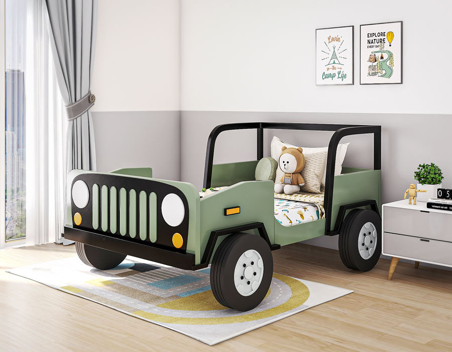 Fun and adventurous children's bedroom featuring a jeep-themed bed in green and black, complete with realistic details like wheels and headlights. The room is bright with natural light from large windows and decorated with playful wall art, a white bedside table, and a plush teddy bear. The decor creates a lively and imaginative space for a child.