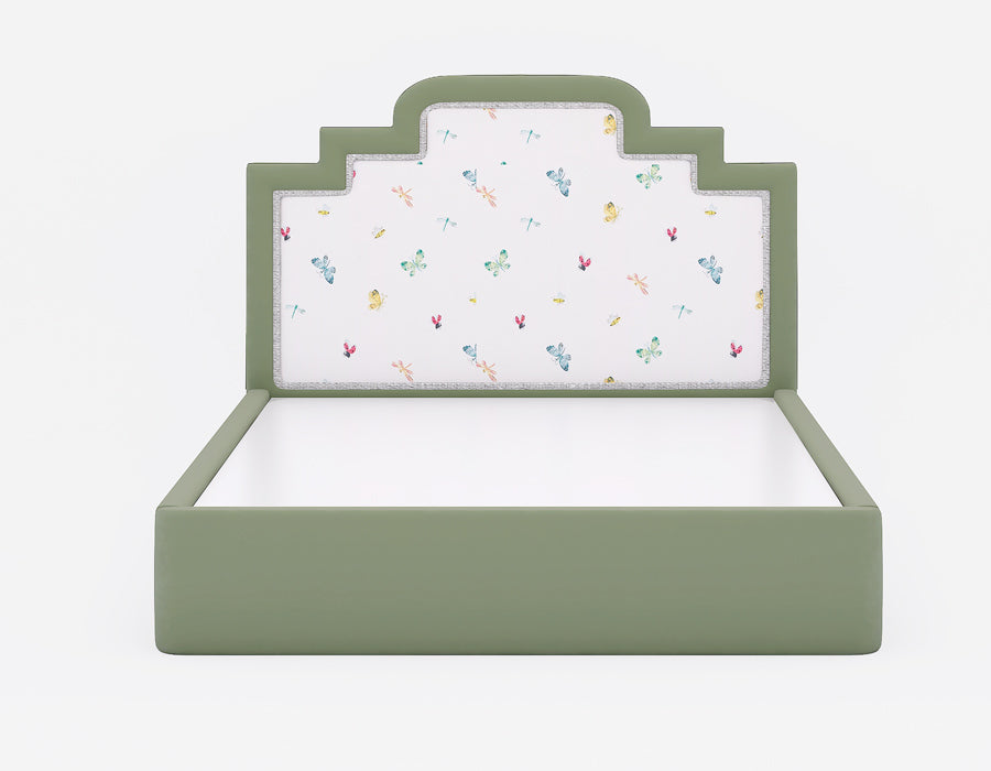 Green upholstered kids' bed with a soft, patterned headboard featuring playful butterfly and dragonfly illustrations. The minimalistic and stylish design creates a perfect blend of comfort and charm, ideal for modern children's bedrooms.