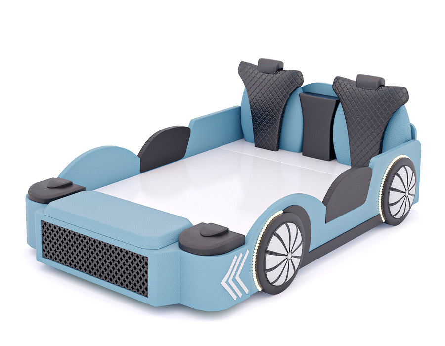 Side angle view of a blue car-themed bed for children, featuring realistic car elements such as a detailed front grille, padded seats, and wheel designs. The bed has gray and black quilted headrests, side panels, and decorative white arrows on the front fenders, enhancing the automotive aesthetic. This playful and comfortable bed is perfect for a child's bedroom.