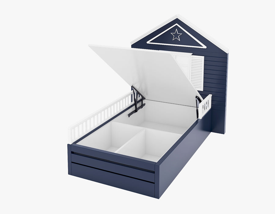 Navy blue children's bed with a house-shaped headboard featuring white shutters and a star decoration, equipped with a lift-up mechanism that reveals spacious storage compartments underneath. The bed includes white side rails for safety, combining playful design with practical storage solutions for a child's bedroom.