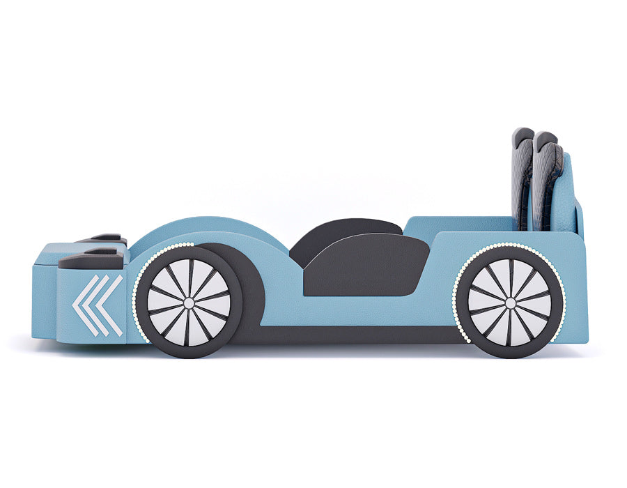 Side view of a blue car-themed children's bed, showcasing its sleek and modern design. The bed features realistic car elements including detailed wheel designs, side mirrors, and a black quilted headrest. The playful and functional bed is perfect for a child's bedroom, blending fun with practicality.