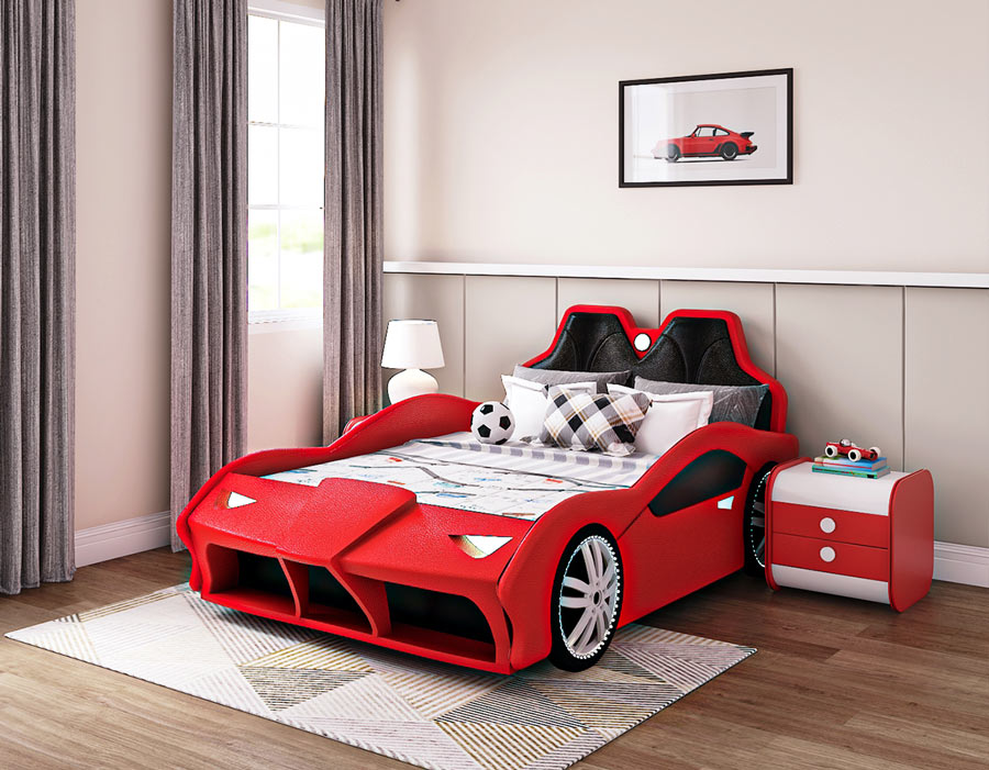 Red car-themed children's bed in a modern bedroom with wooden flooring and light-colored walls. The bed features a sporty design with sleek curves, large wheel details, and a cushioned headboard resembling car seats. The bed is styled with colorful pillows and a playful bedding set, alongside a matching red nightstand with drawers. A framed car illustration hangs on the wall, complementing the automotive theme.