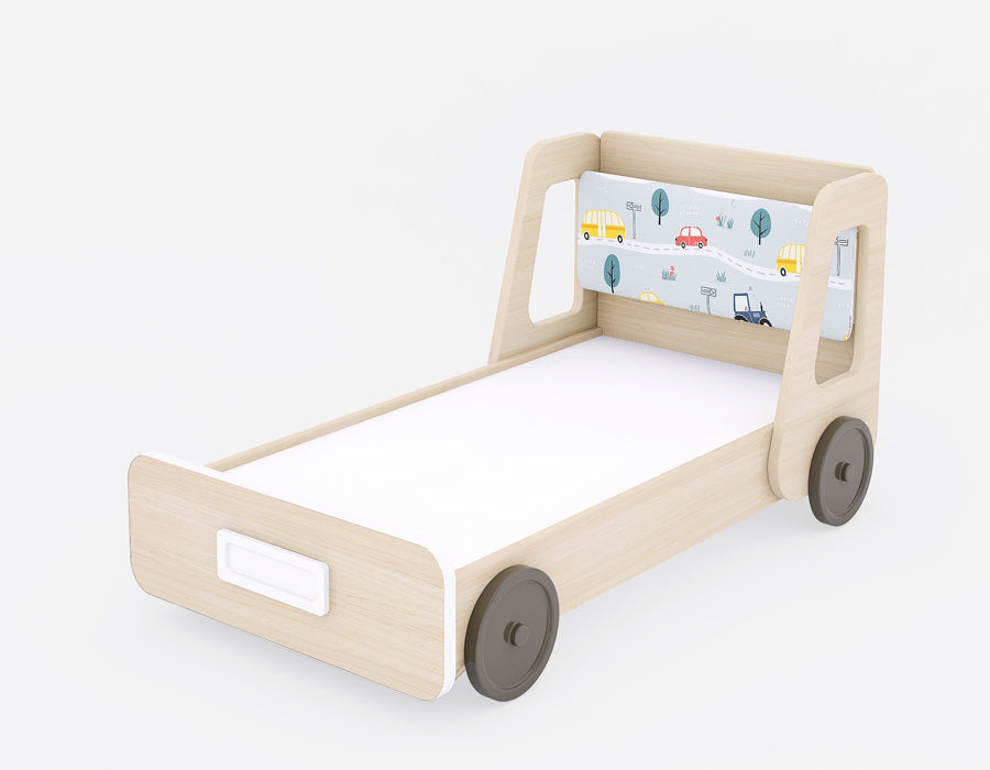 Side-angle view of a wooden kids' bed with a playful road-trip theme. The bed features light wood accents, integrated storage at the front with a sleek handle, and wheels on the sides for a creative design touch. The headboard is decorated with vibrant illustrations of cars, buses, and trees, enhancing the room’s charm. Ideal for children’s spaces, combining style, storage, and a fun aesthetic.