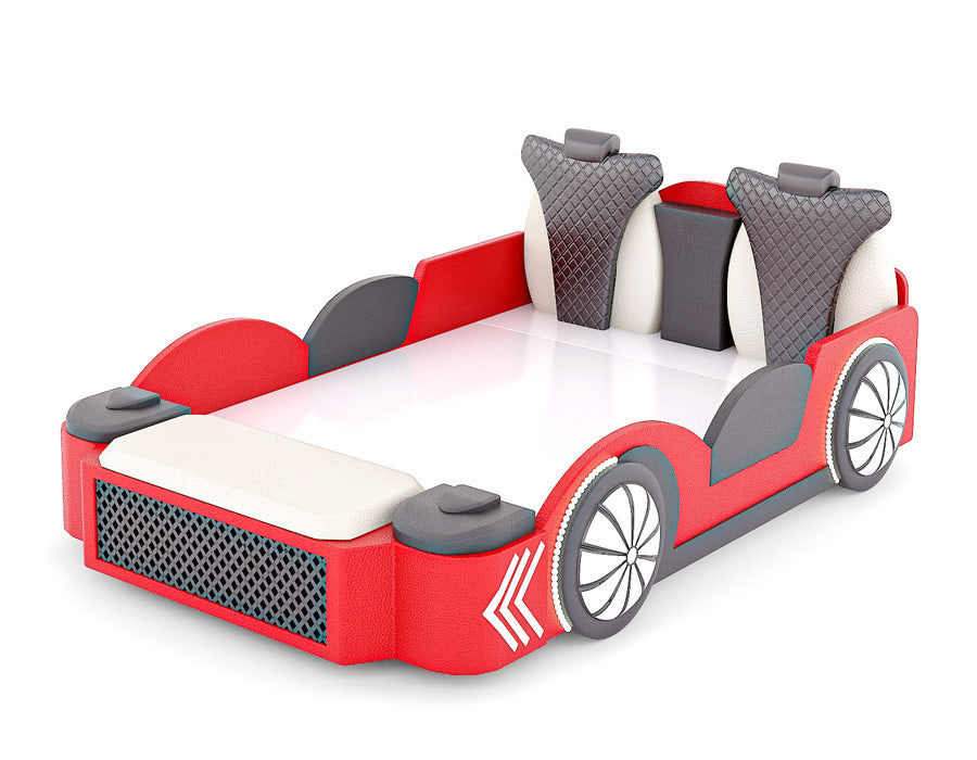 Side angle view of a red car-themed bed for children, featuring realistic car elements such as a detailed front grille, padded seats, and wheel designs. The bed has gray and black quilted headrests, side panels, and decorative white arrows on the front fenders, enhancing the automotive aesthetic. This playful and comfortable bed is perfect for a child's bedroom.