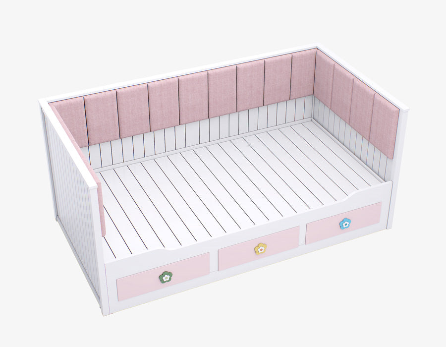 Side view of a stylish girl's trundle bed in white with pink drawers adorned with floral motifs and a plush pink upholstered headboard.